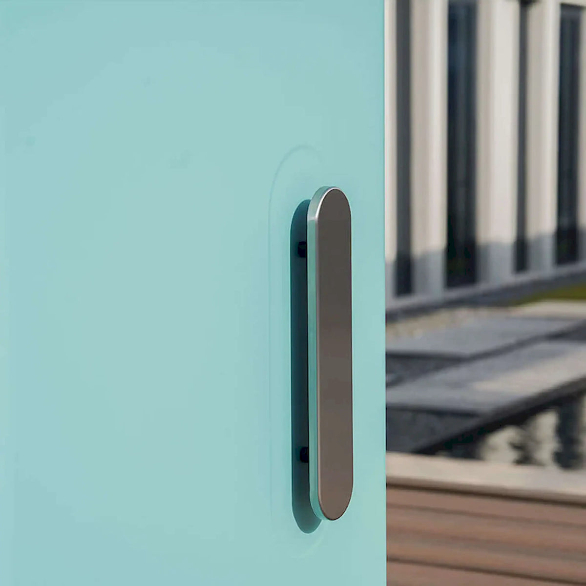 Green powder-coated grill side handle on cabinet front