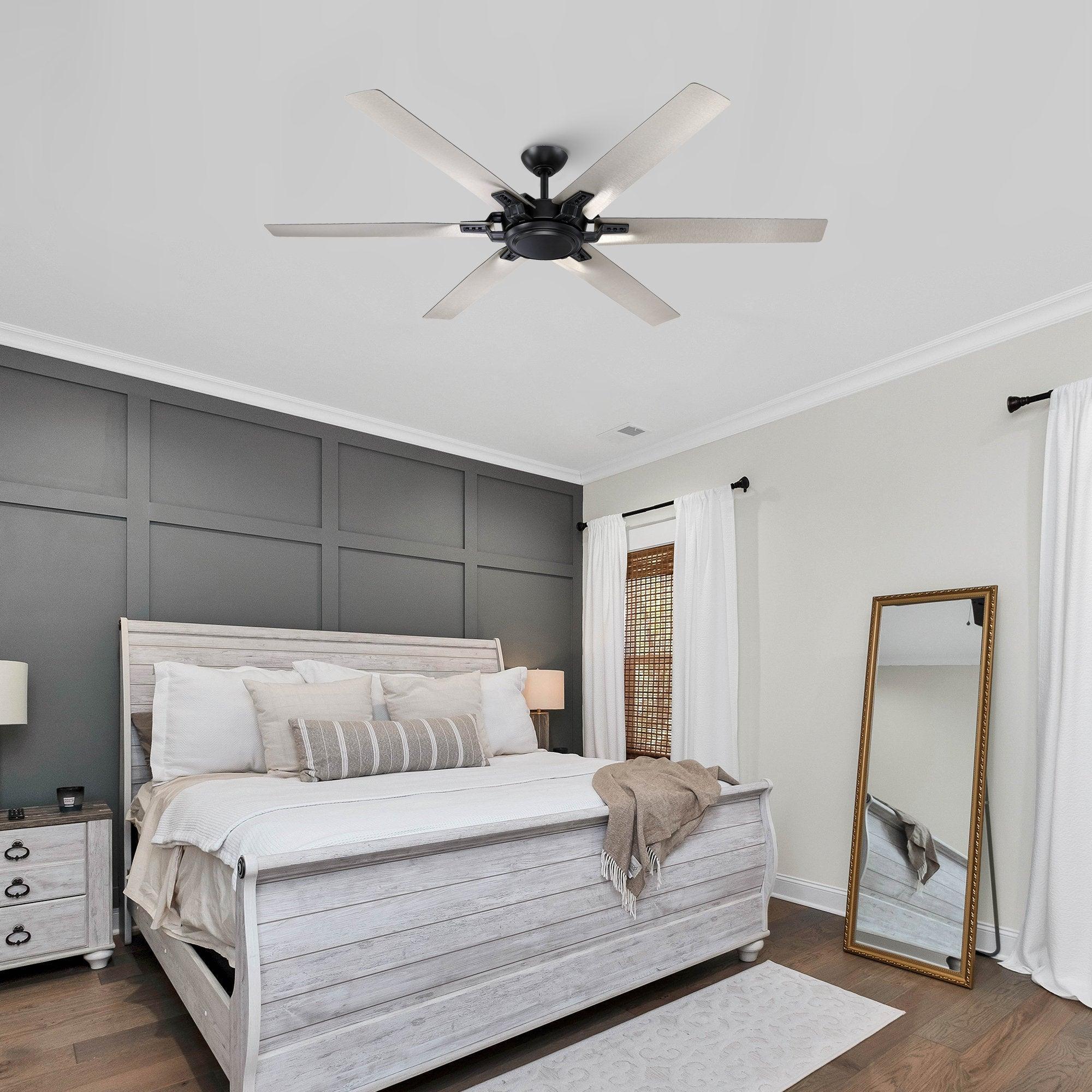 Black ceiling fan with five light wood-toned blades in a bedroom ceiling