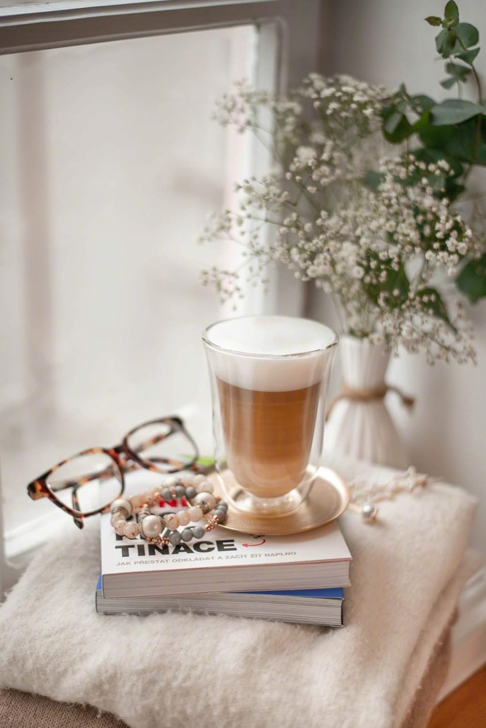 Double wall latte macchiato glass with layered coffee and foam top, clear glass