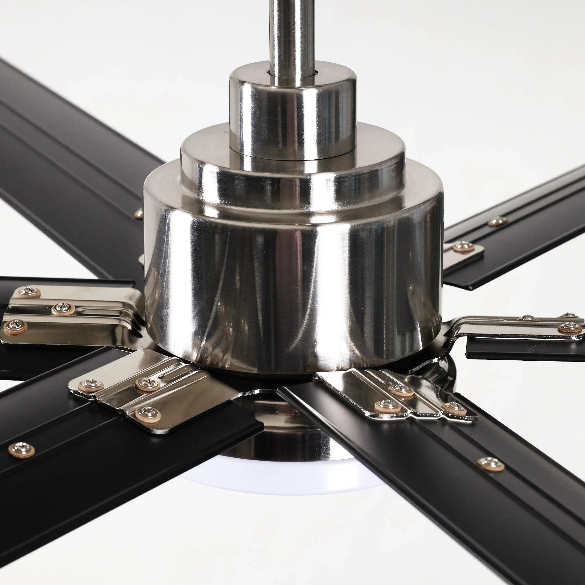Chrome fan motor housing with mounting hardware and six dark blades