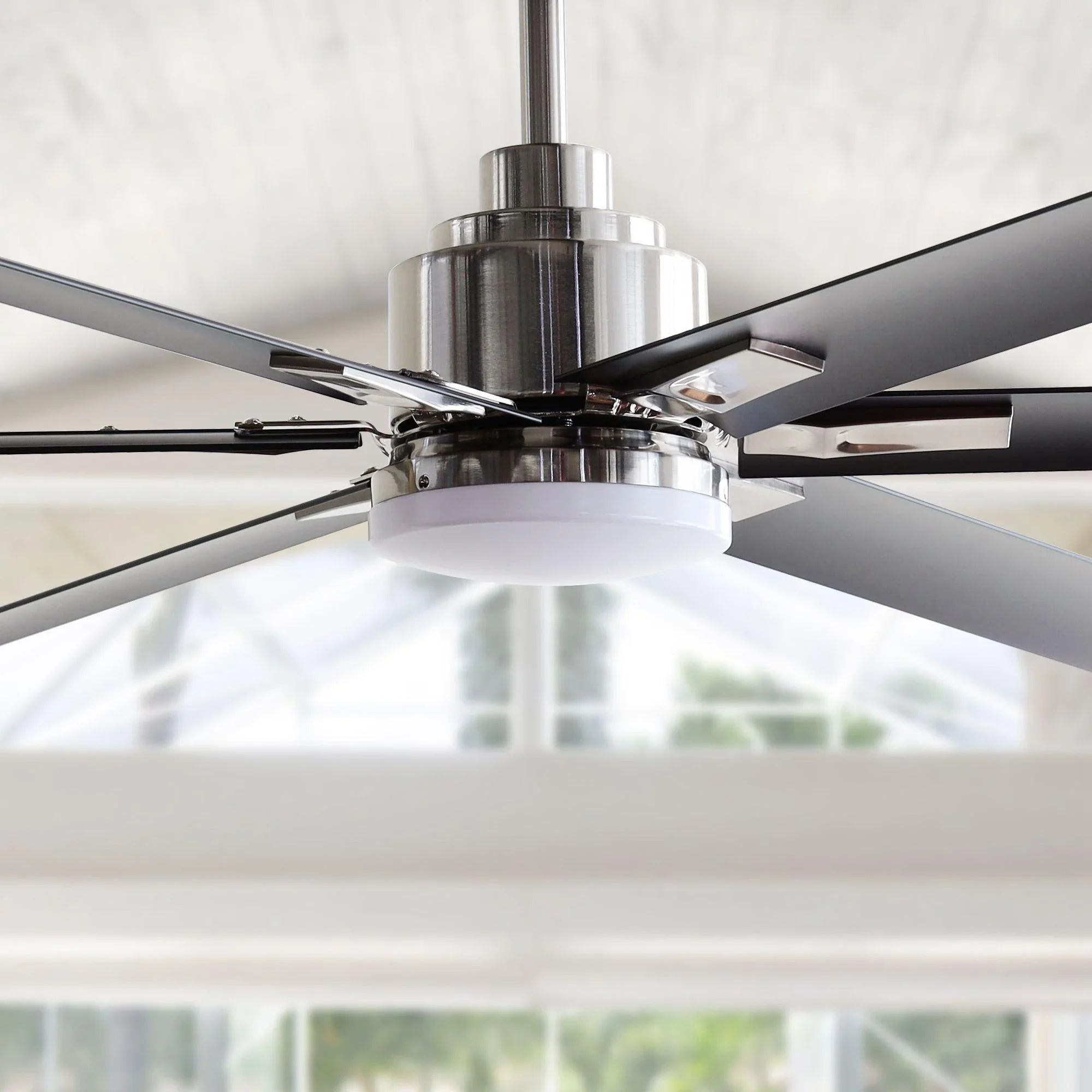 Chrome ceiling fan with six dark blades and integrated round light fixture