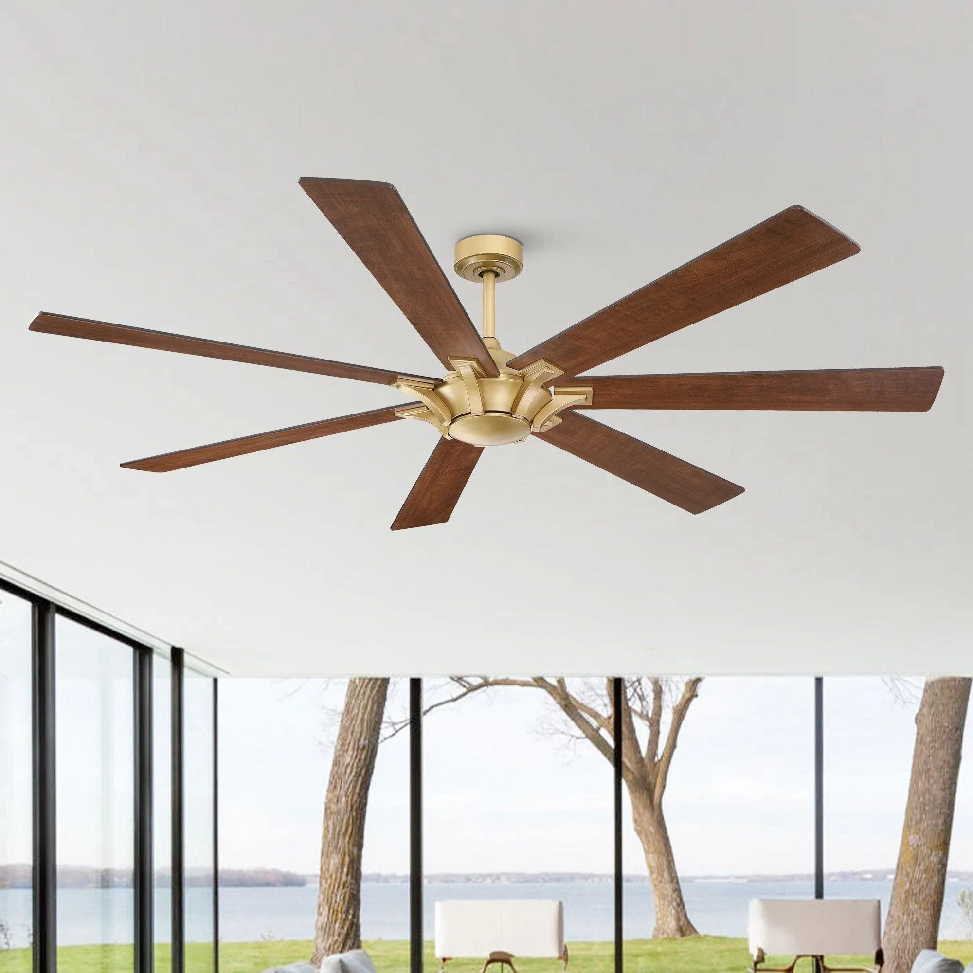 Golden ceiling fan with five wood blades on an open-plan room ceiling