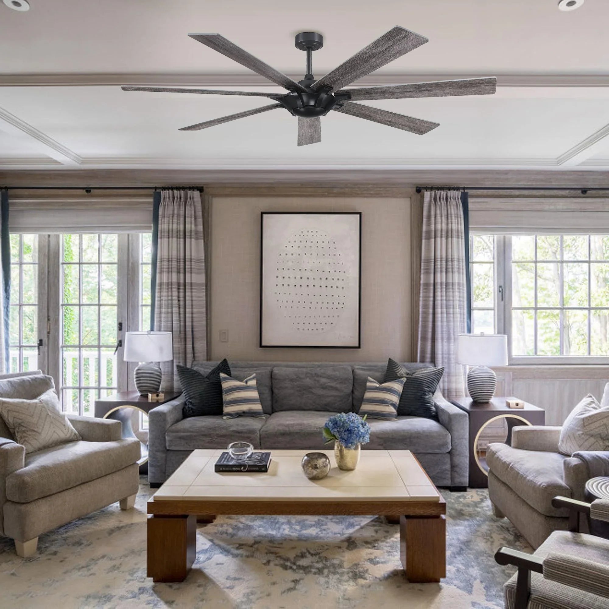 Black ceiling fan with five gray wood-finish blades mounted on a downrod