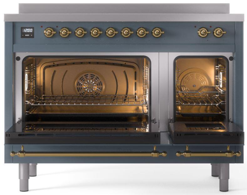 Blue-grey induction range with both ovens open, interior lights, and brass trim