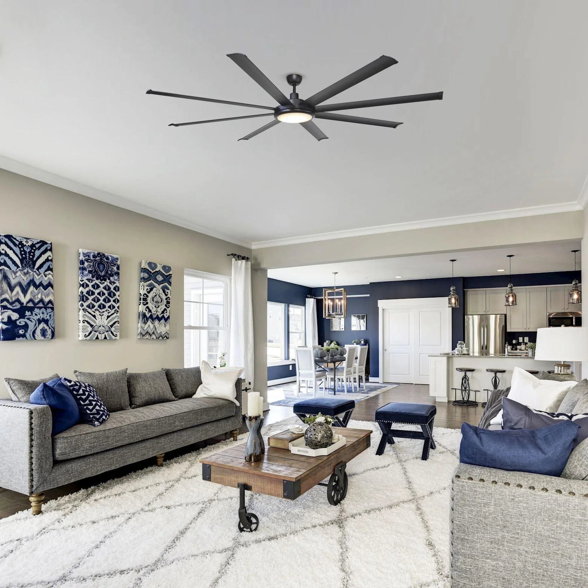 Black ceiling fan with integrated light and long downrod mount in a living room