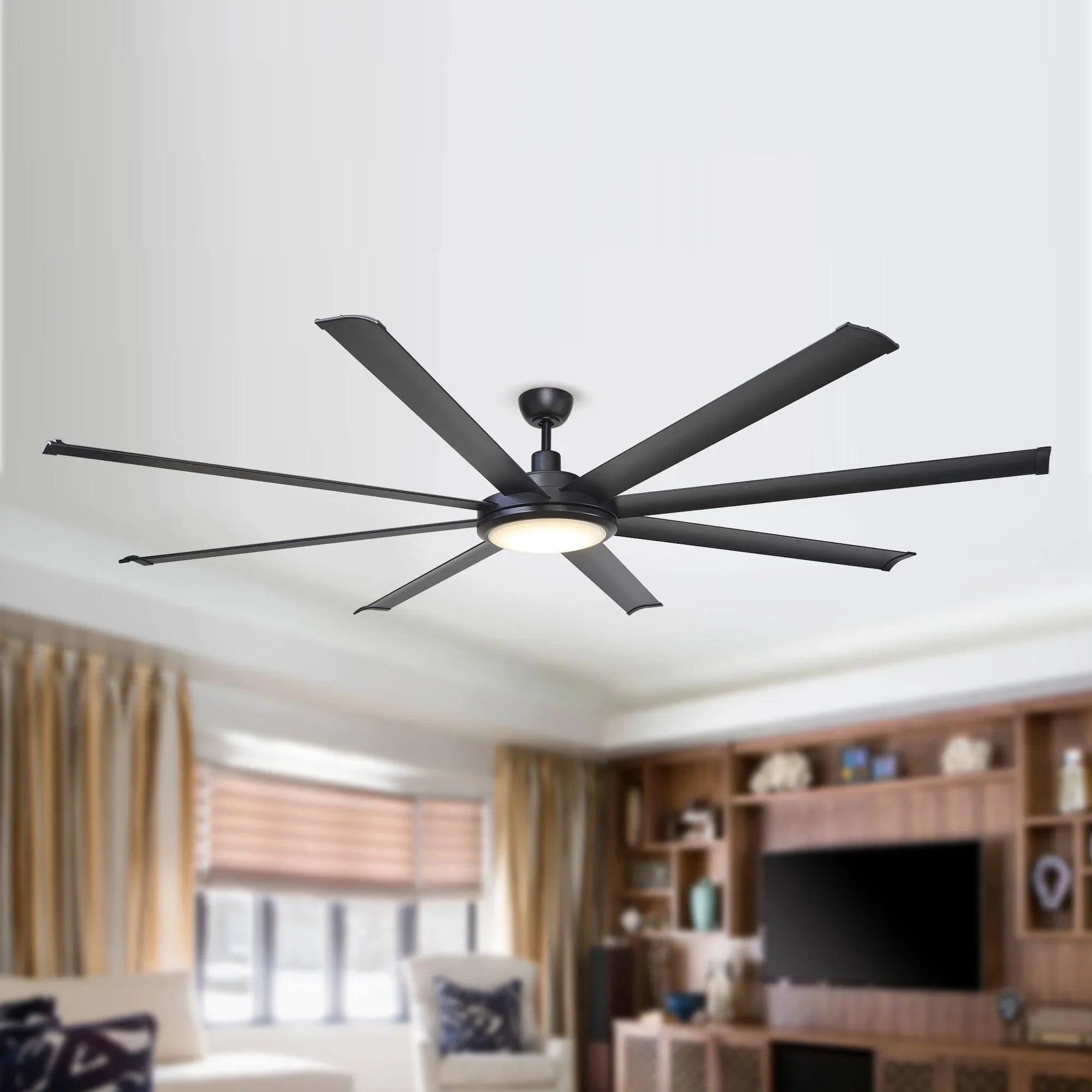 Black ceiling fan with integrated light and five blades on a ceiling