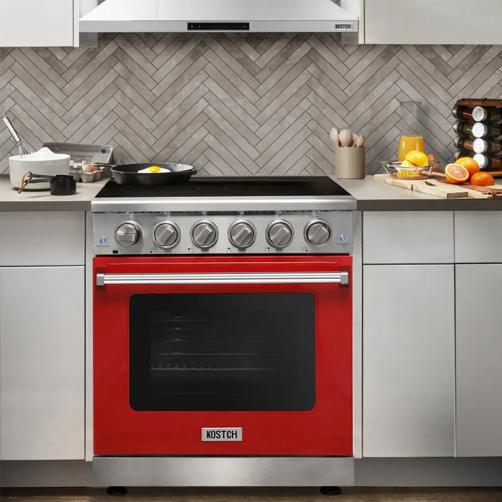 Red electric range with black glass cooktop, stainless knobs, and built-in oven window