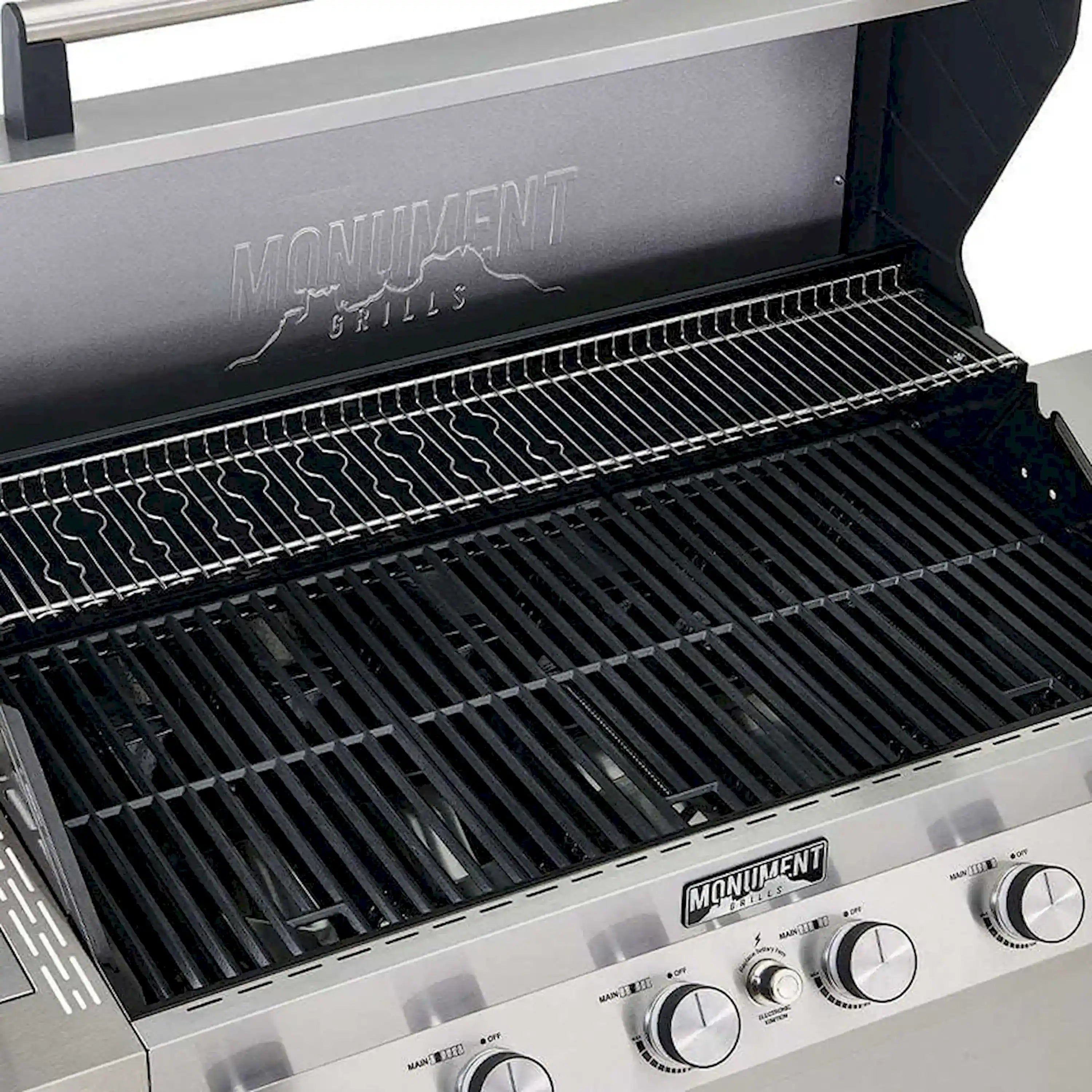 Grill cooking grates inside open Monument gas grill with burner components