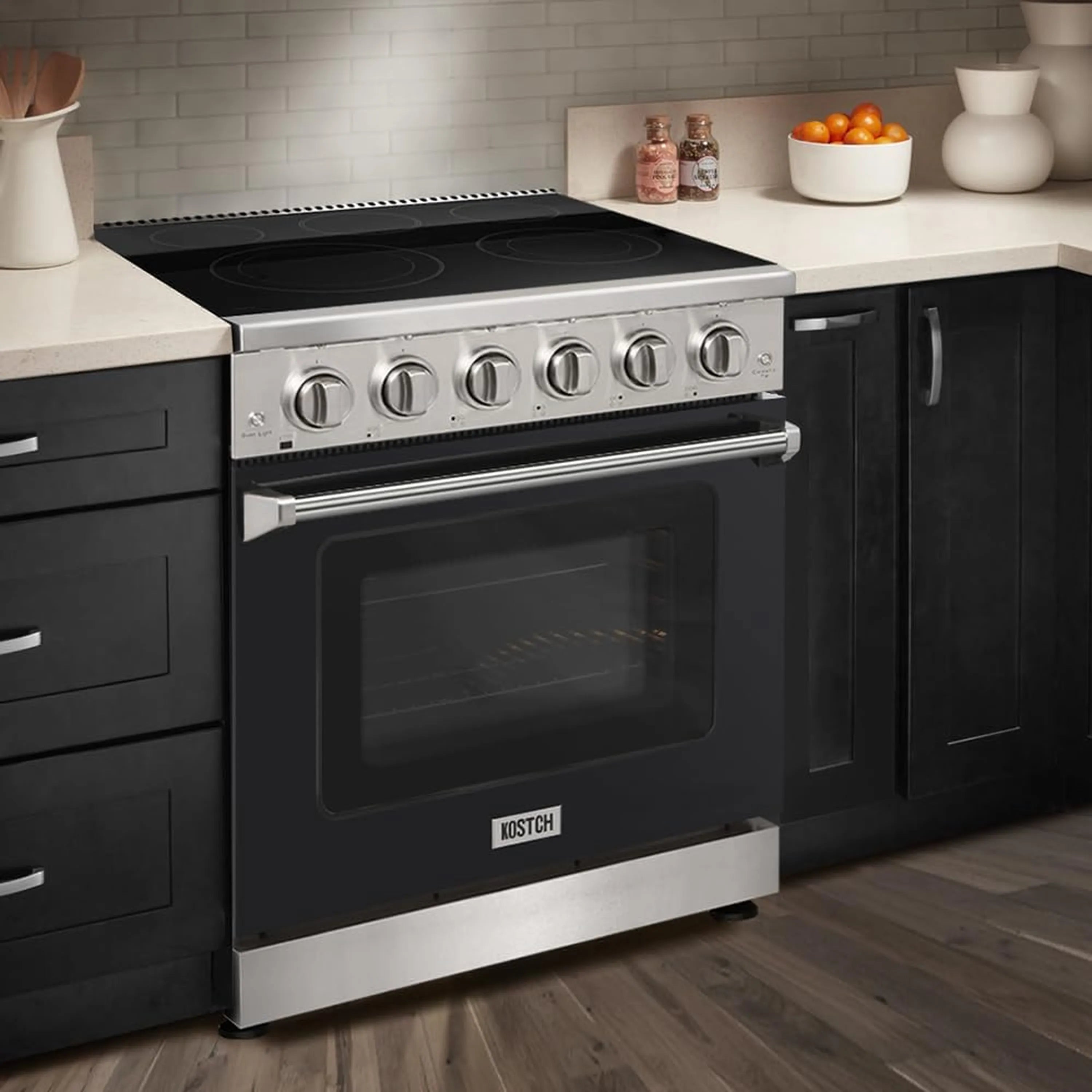 Black electric range with glass cooktop and closed oven door