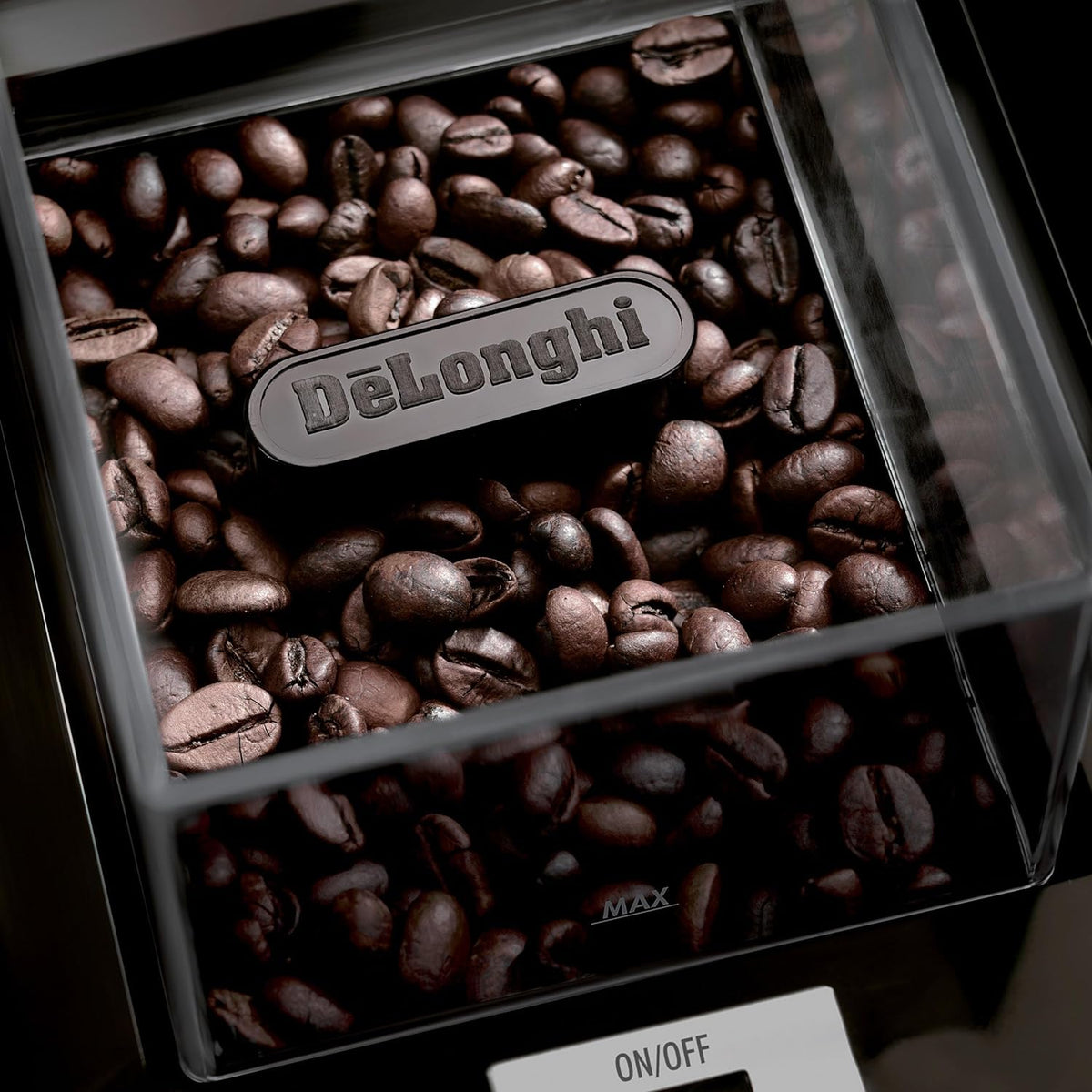 Clear hopper filled with coffee beans on De'Longhi conical burr grinder