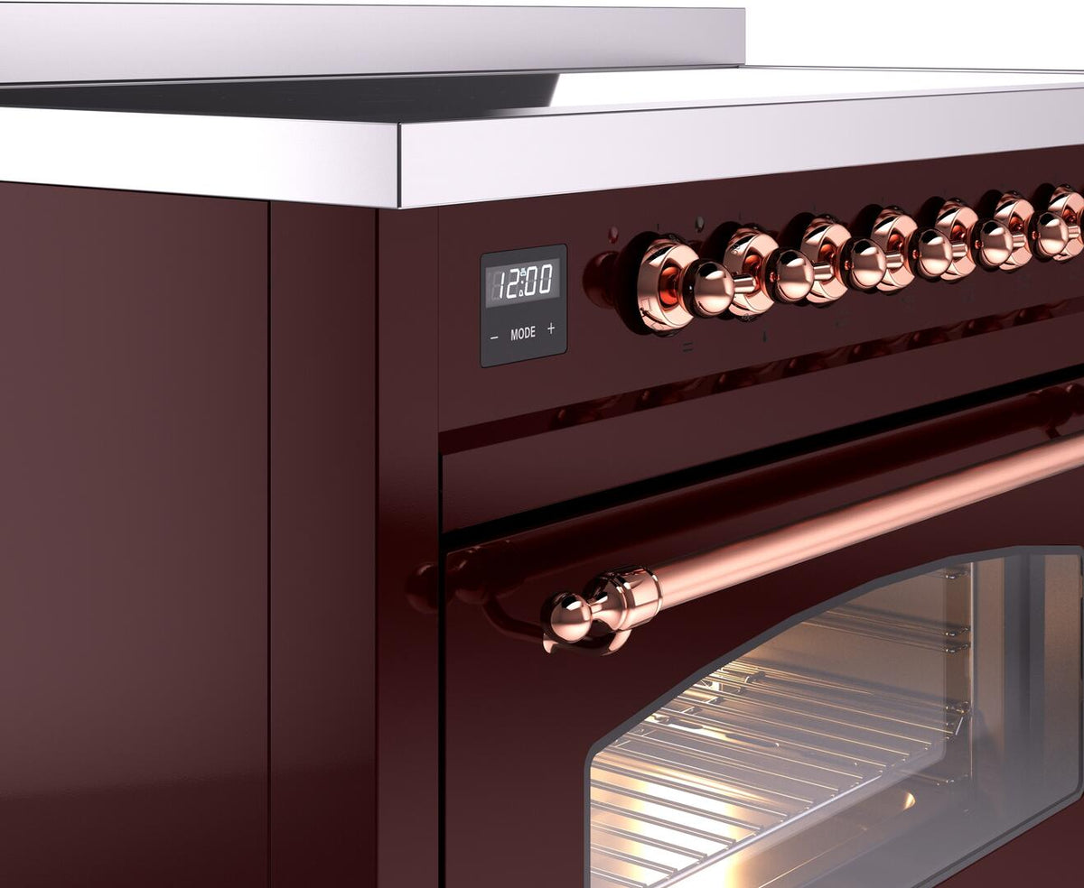 Electric induction range control panel with copper knobs and digital display, close-up