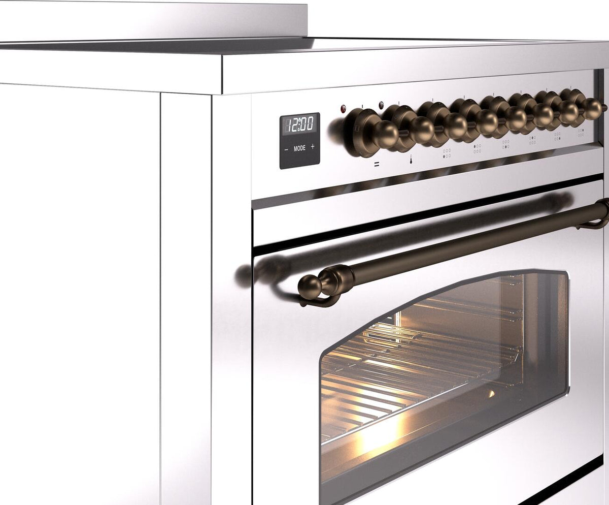 Freestanding electric induction range control panel with bronze knob row and oven handle