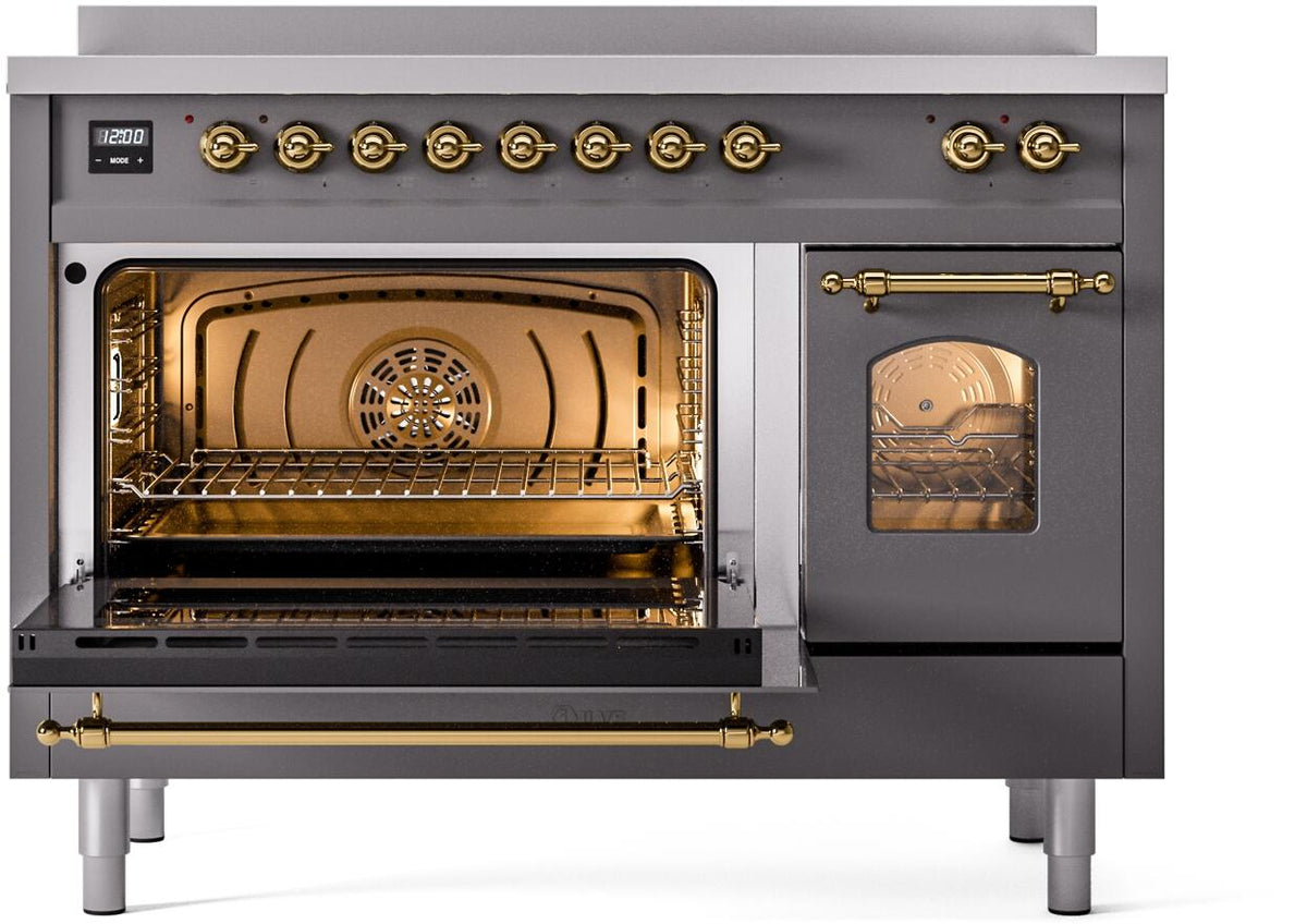 Open oven door on matte graphite induction range; brass handle bar and warm interior rack view.