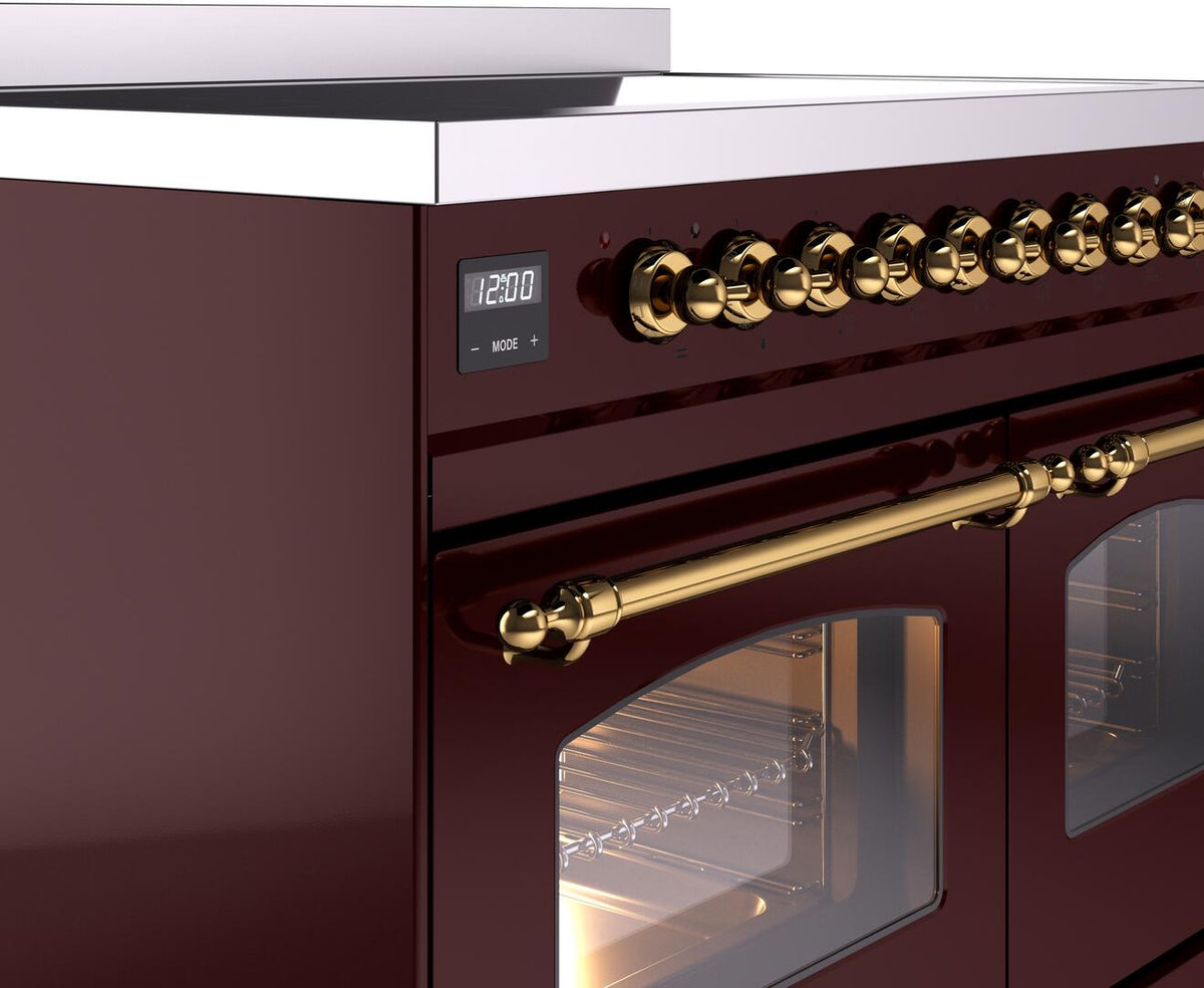 Brass knob row and control panel on burgundy electric induction range