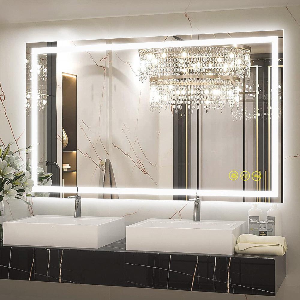 Backlit rectangular LED bathroom mirror over double sinks with warm white light