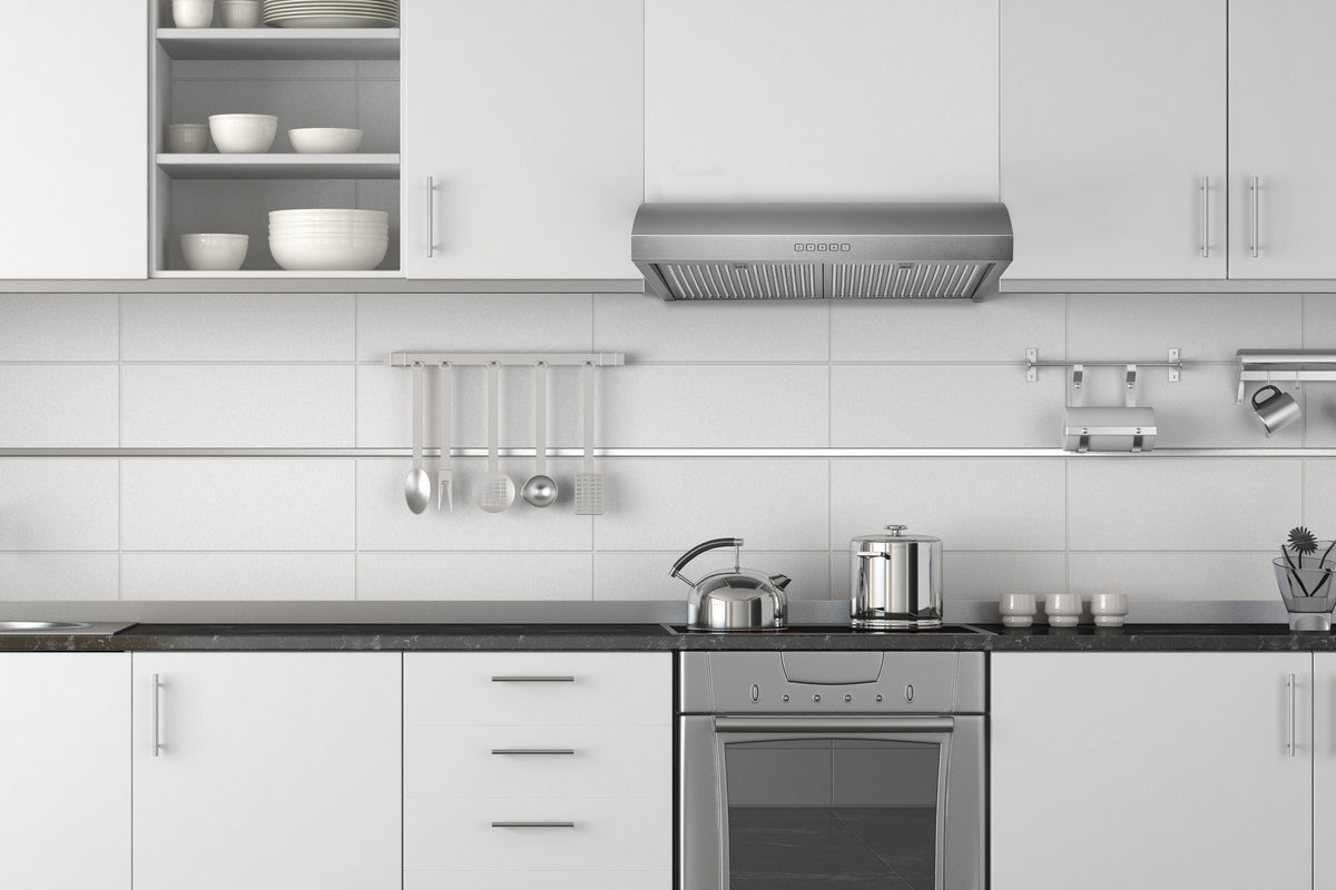 Stainless steel under-cabinet range hood installed under kitchen cabinets, with metal filter grilles