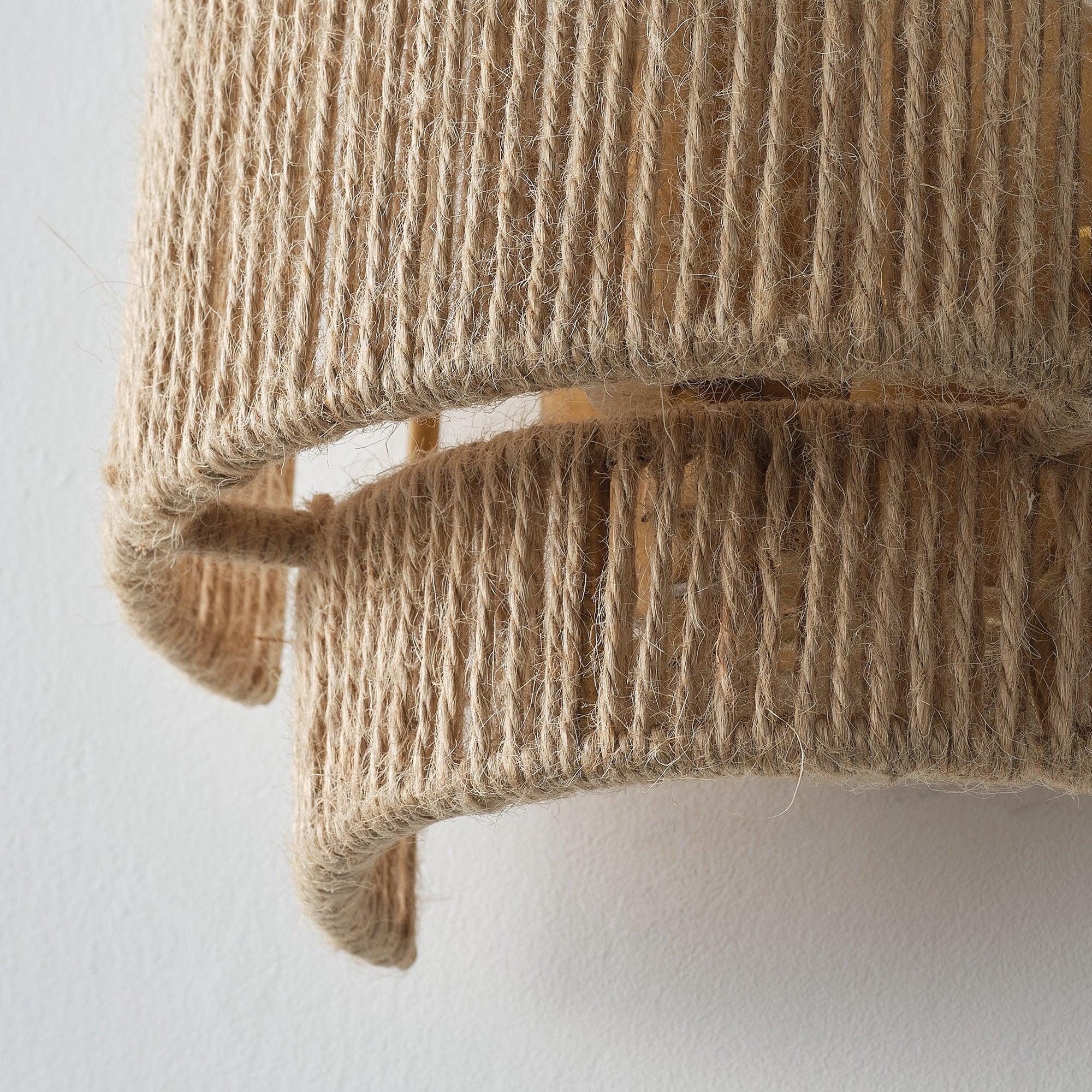 Brown rattan wall sconce shade with woven vertical strand texture