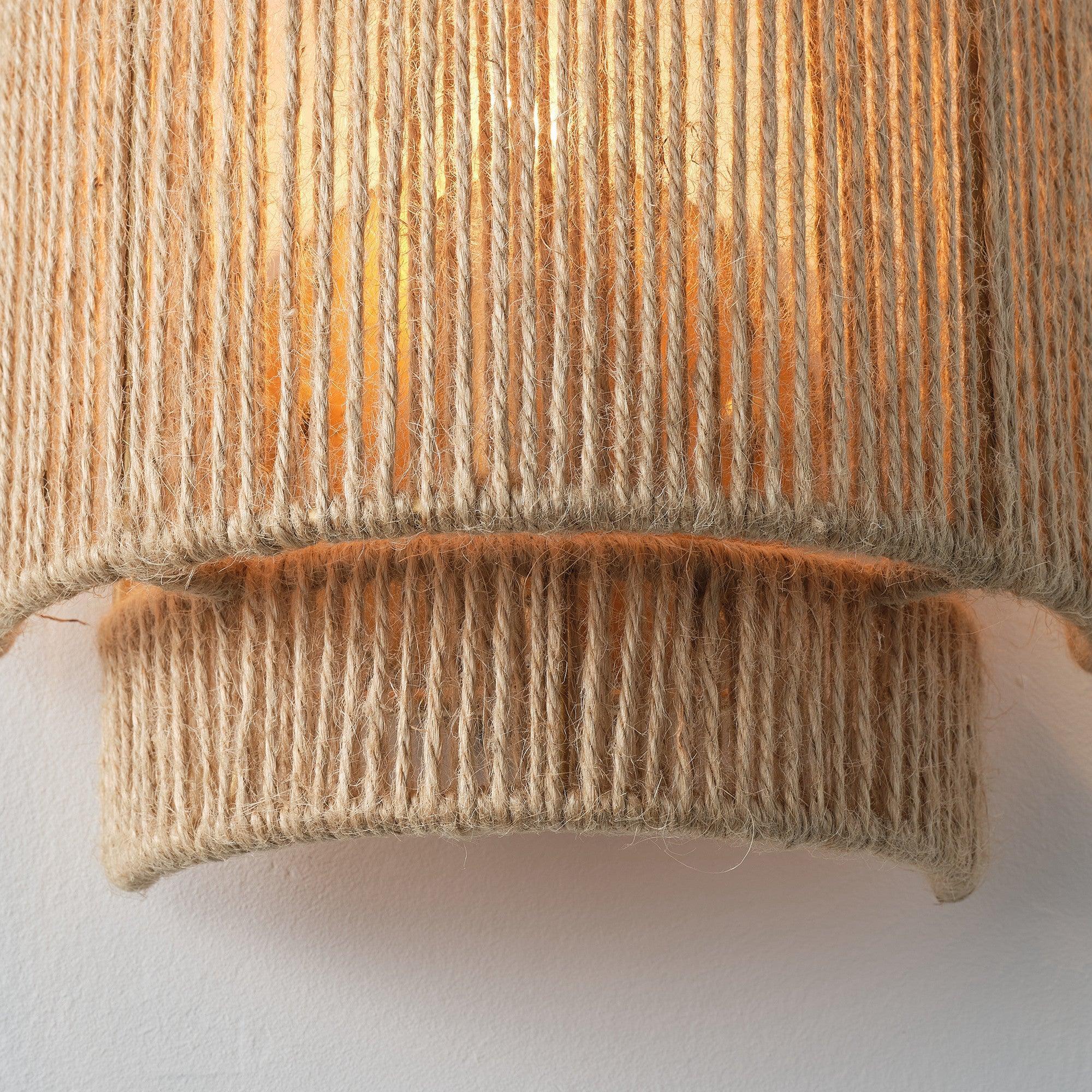 Close-up brown rattan wall sconce shade with woven vertical strands