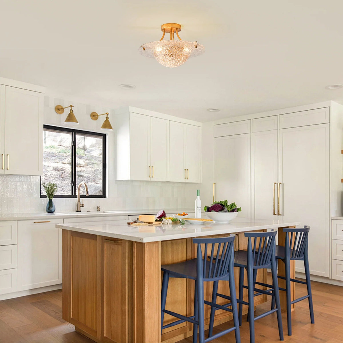Golden semi-flush mount ceiling light with clear textured shade over a kitchen