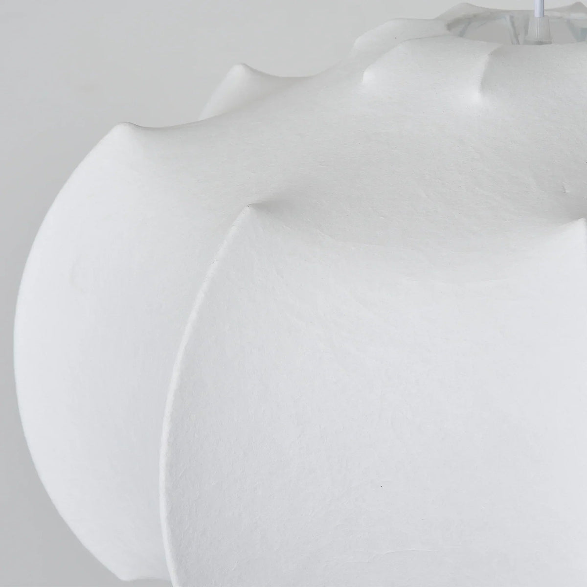 Close-up of white wabi-sabi pendant shade with soft, scalloped edges