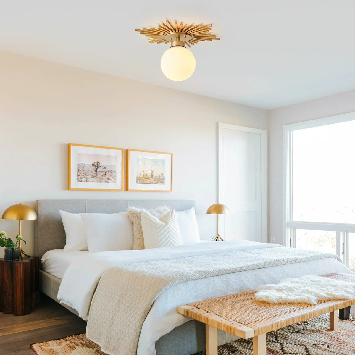 Golden sunburst semi-flush ceiling light with frosted glass globe shade