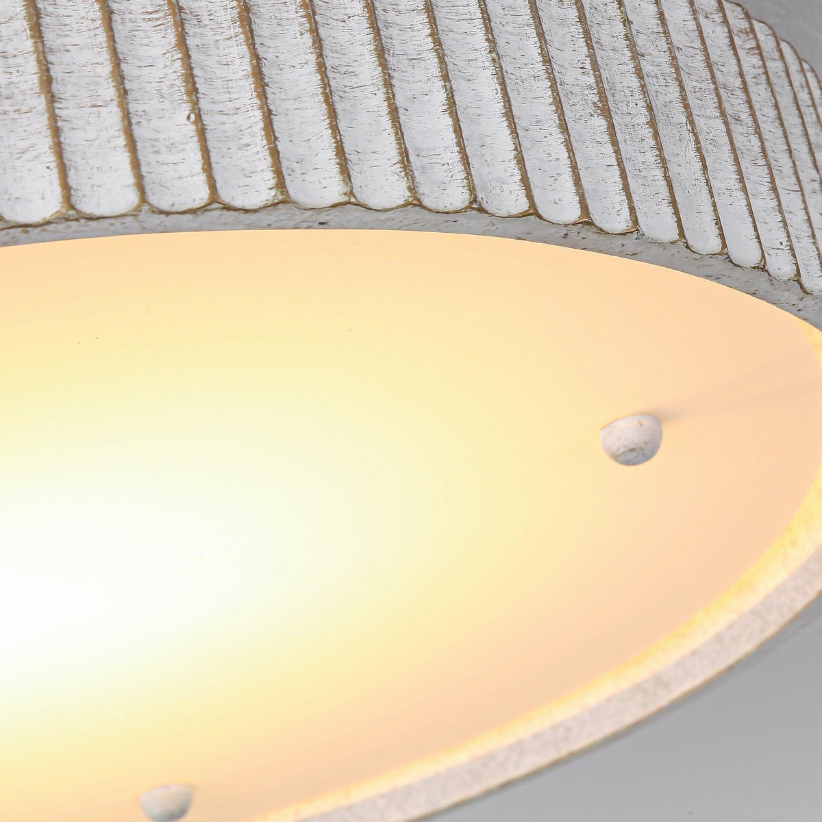 Close-up of white flush mount LED light diffuser with mounting screws