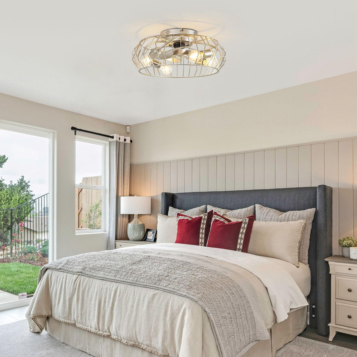 Silver flush mount ceiling fan with light and wire cage on a residential ceiling