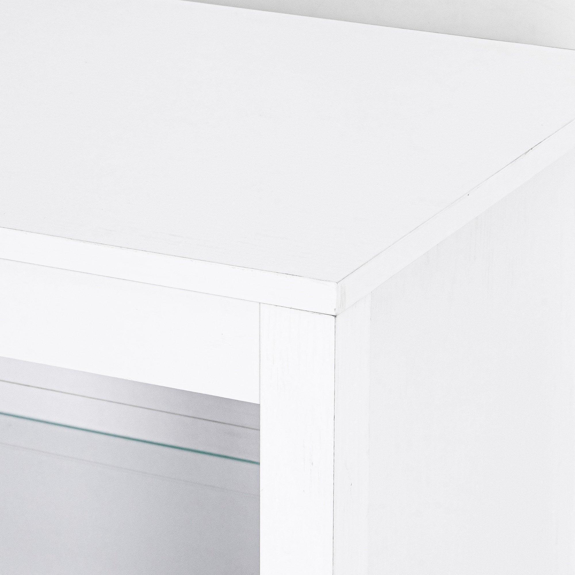 White LED TV stand corner detail with smooth cabinet edge and panel seam