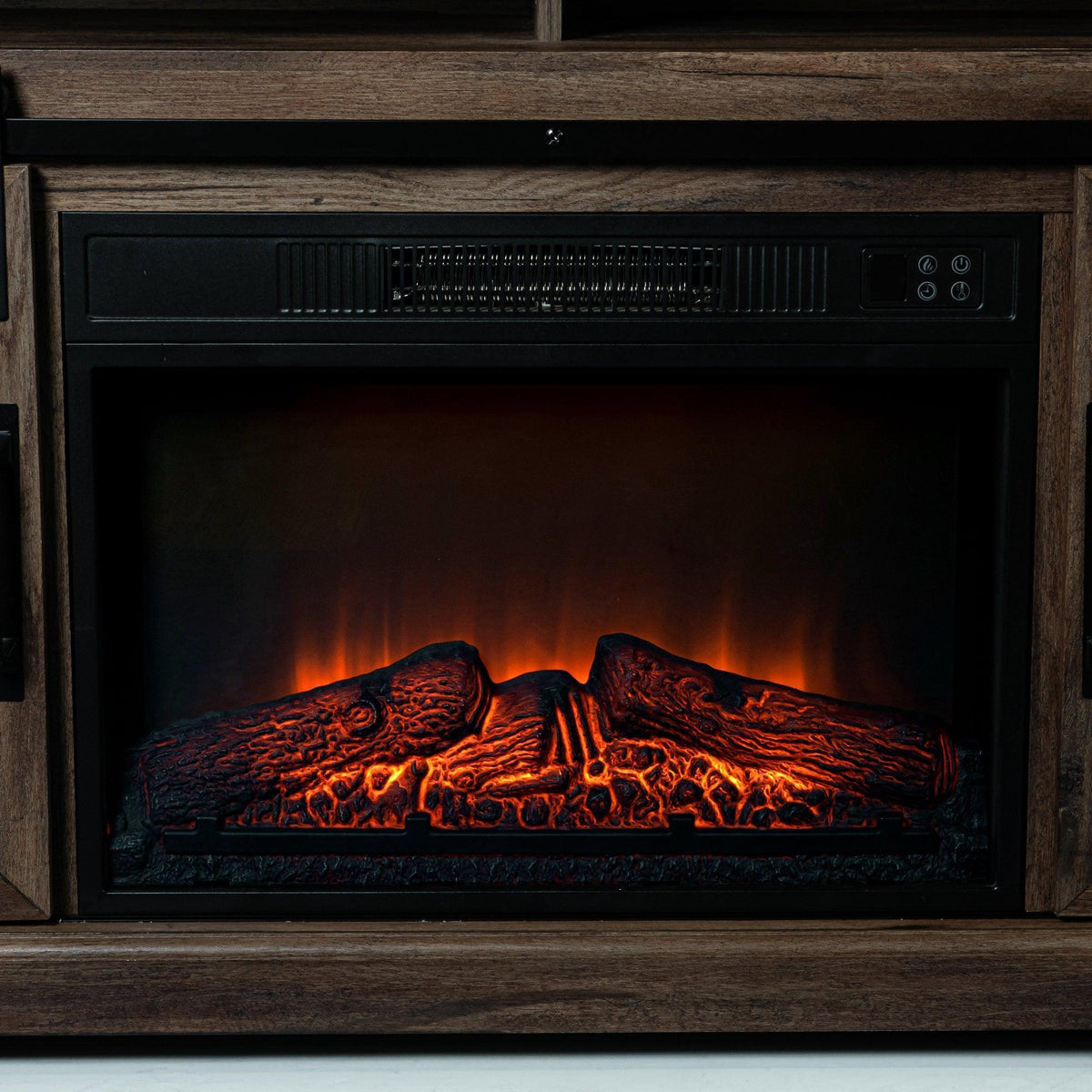 Electric fireplace insert with glowing flames inside dark wood TV stand