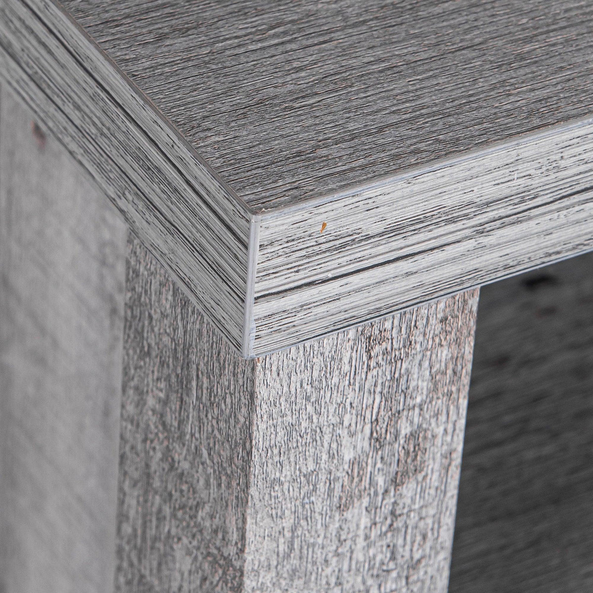 Textured gray wood nightstand cabinet corner with distressed finish