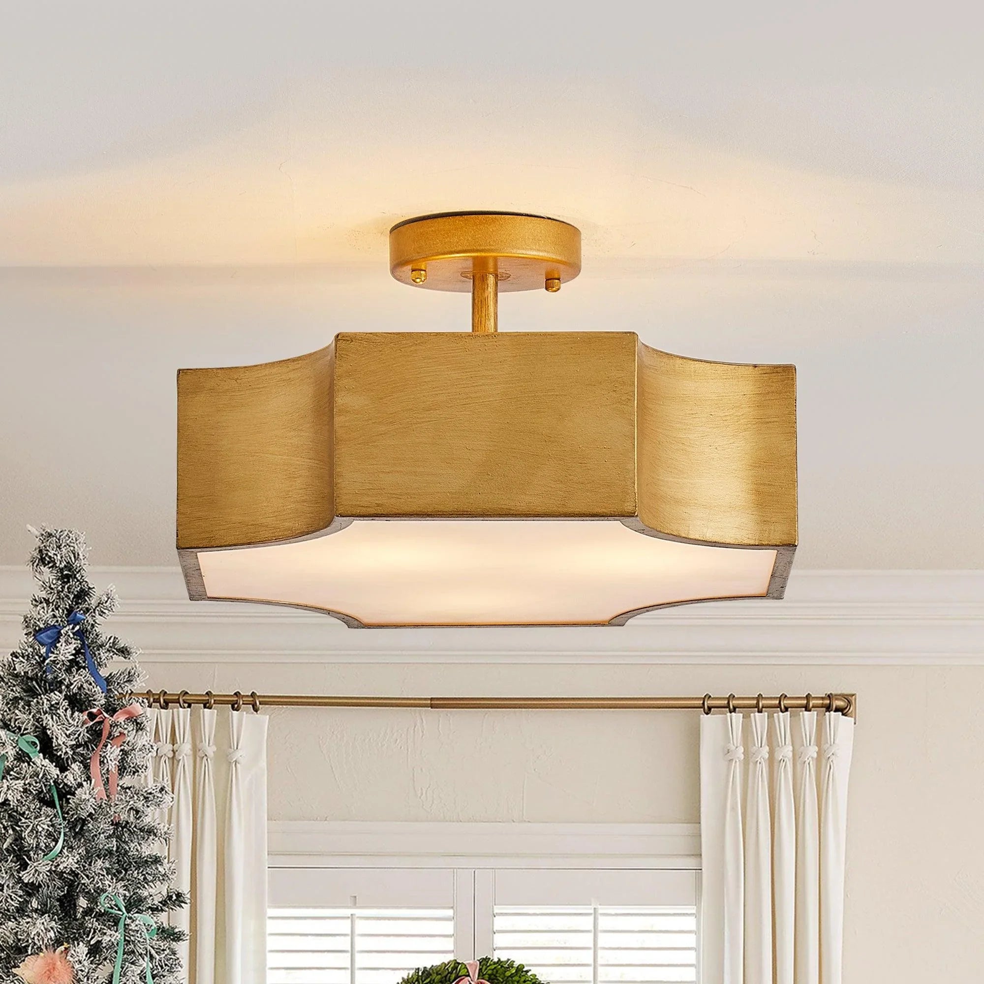 Brushed gold semi-flush mount ceiling light with three lights and white acrylic diffuser