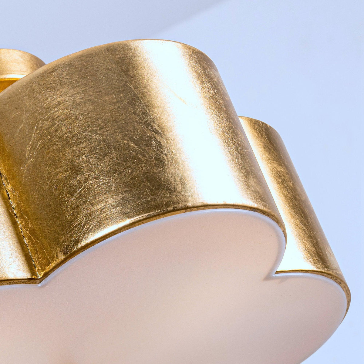 Gold ribbed drum shade with white inner diffuser and central vertical support