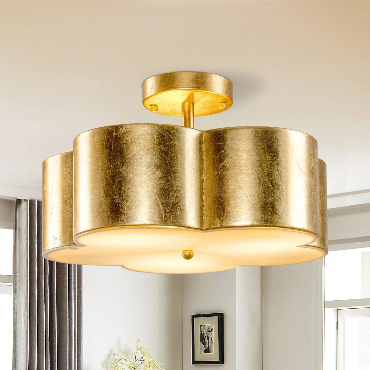 Golden semi-flush ceiling light with metallic drum shades and warm glass diffusers