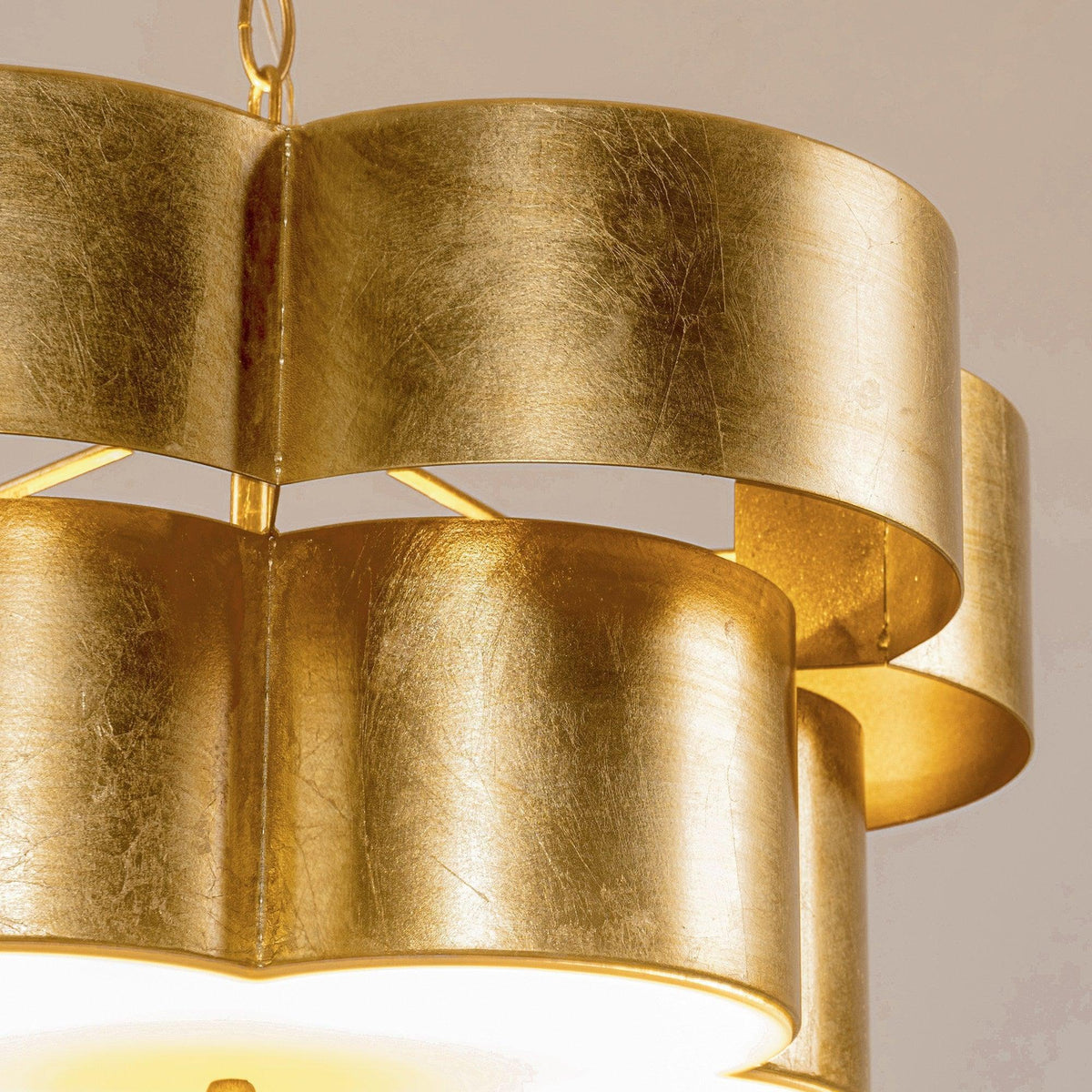 Close-up of golden layered drum shade panels on a hanging pendant light