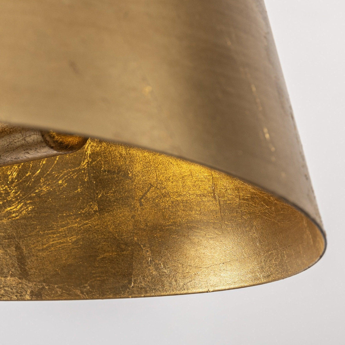 Gold drum shade with textured metal finish and curved bottom edge