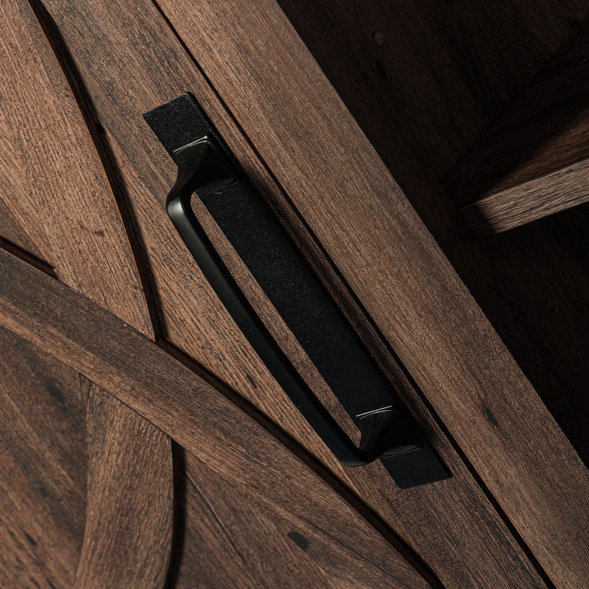 Black bar-style handle on dark brown cabinet door