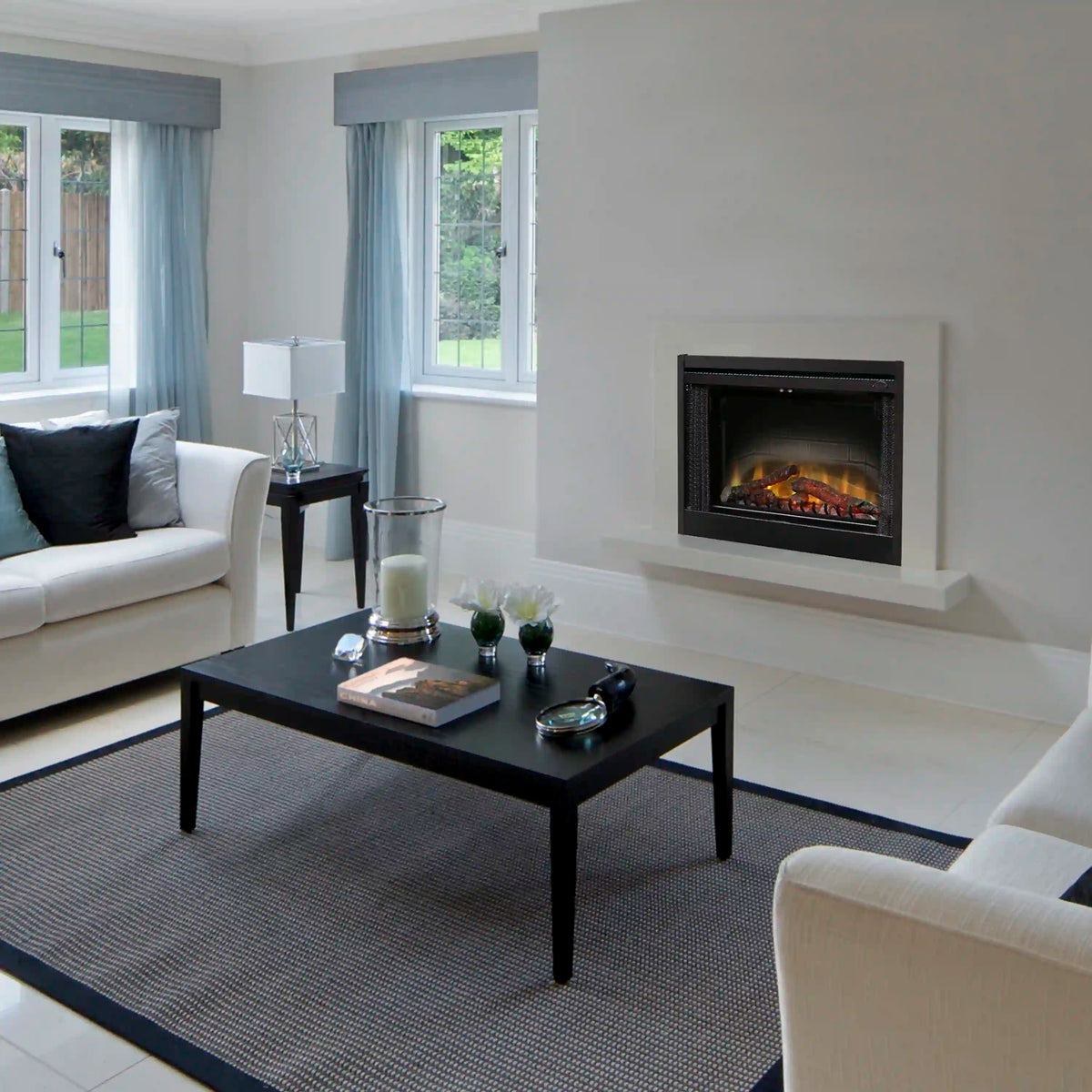 Black built-in electric fireplace insert with glowing fire behind glass