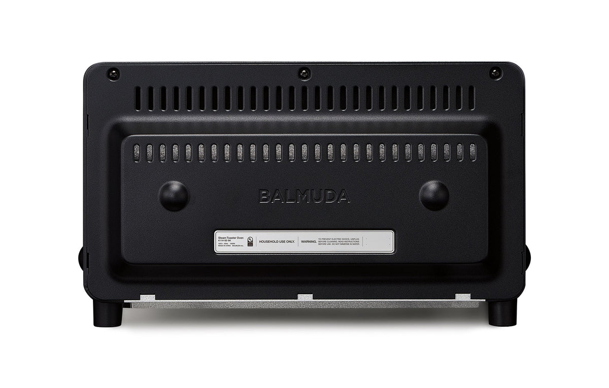 Black countertop toaster oven back panel with ventilation slots and BALMUDA label