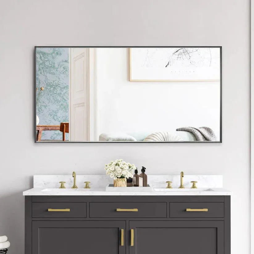 Black aluminum-framed wall mirror with reflective glass above bathroom vanity