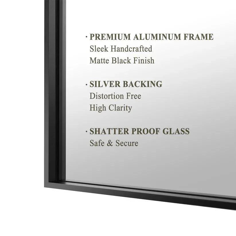 Close-up of matte black aluminum wall mirror frame with glass edge.