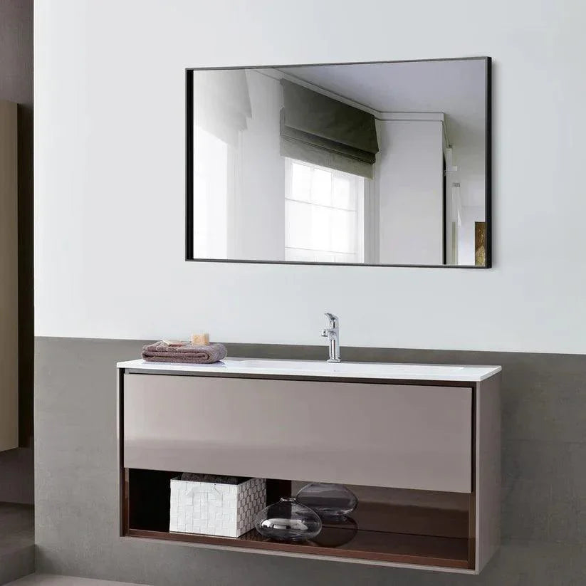 Black framed rectangular wall mirror with reflective glass above bathroom vanity