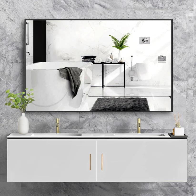 Black aluminum-framed rectangular wall mirror with reflective glass above vanity