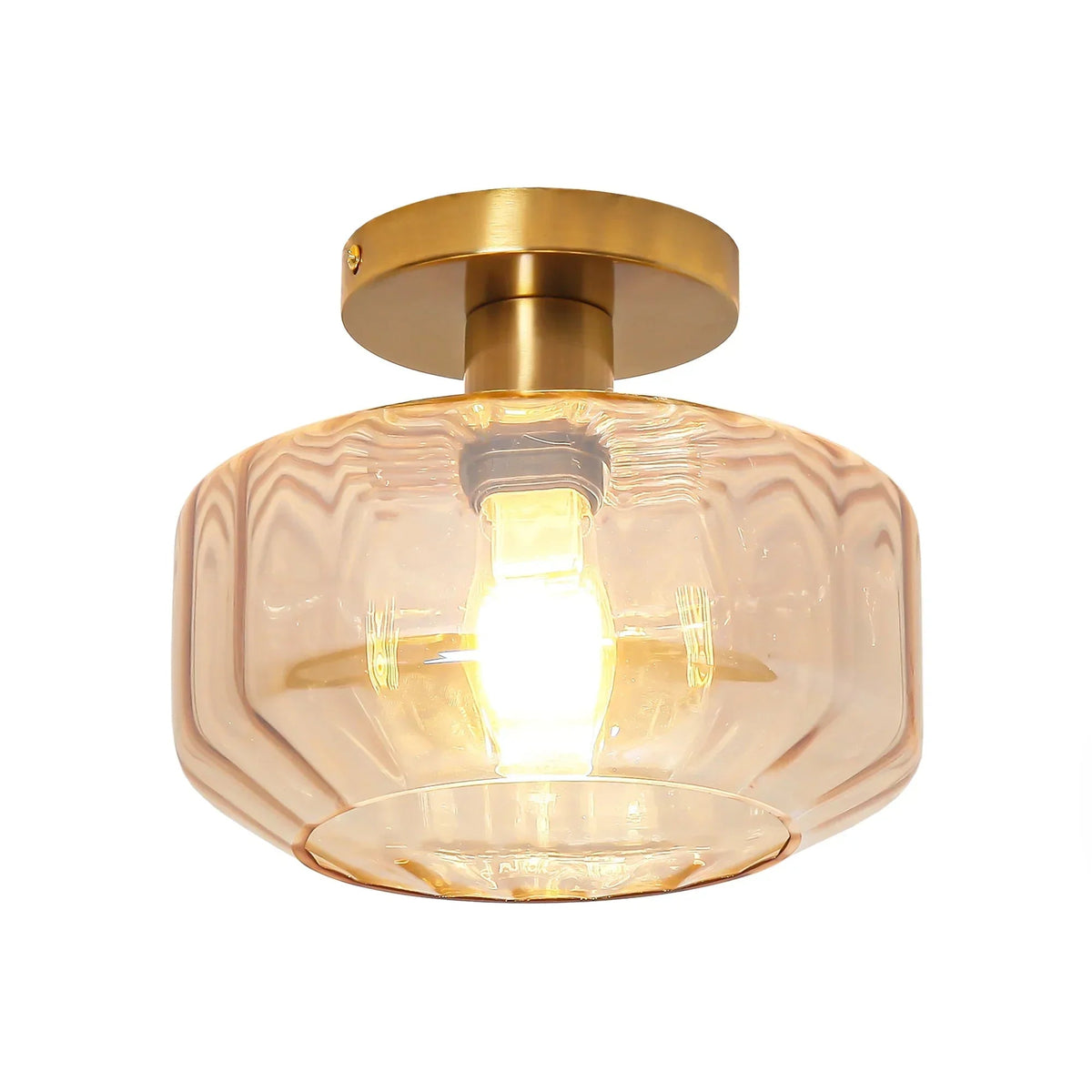Golden semi-flush mount ceiling light with clear ribbed glass shade over lit bulb