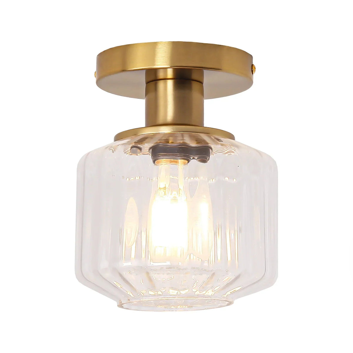 Golden flush-mount ceiling light with clear faceted glass shade and visible bulb