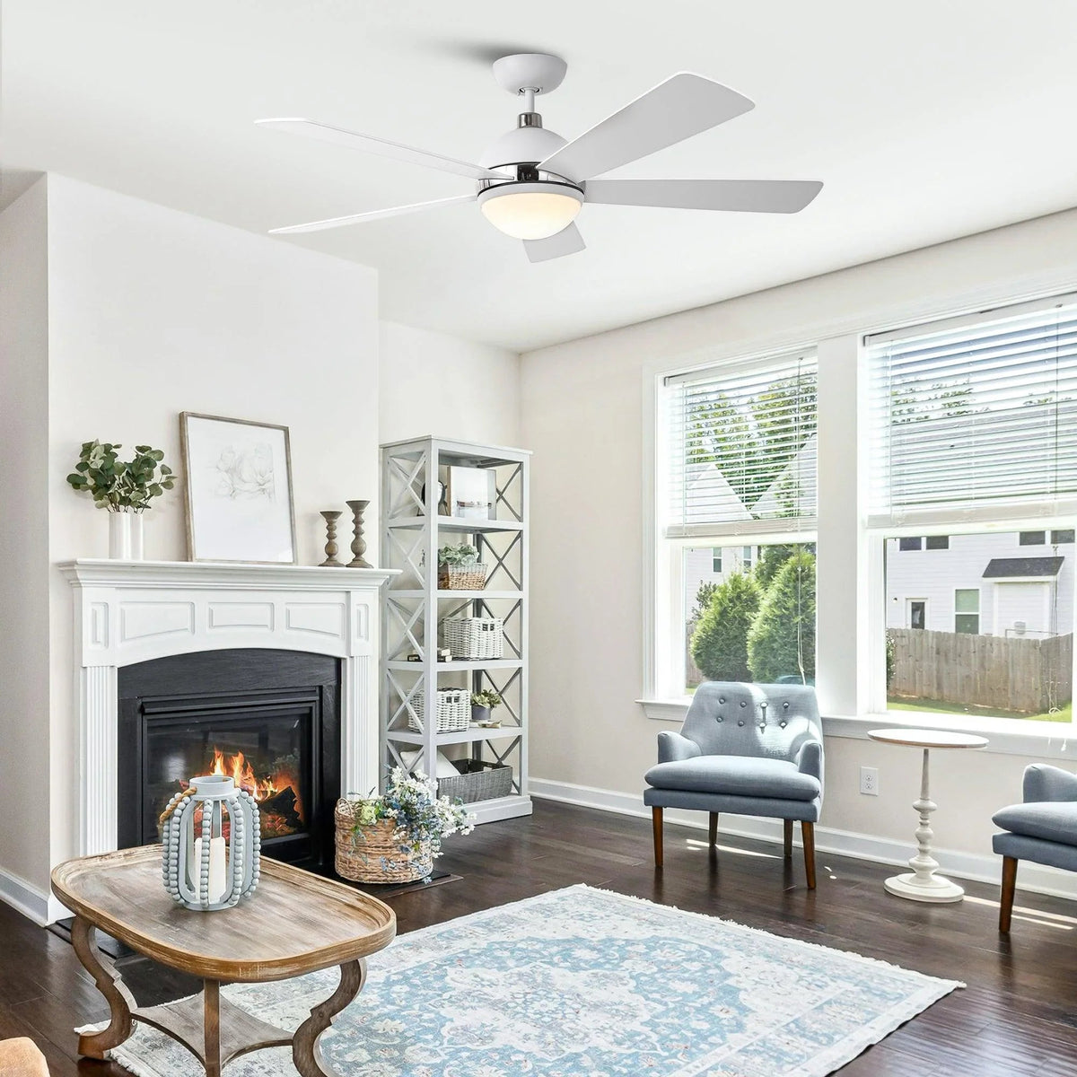 Ceiling fan with five white blades and frosted LED light under a chrome hub