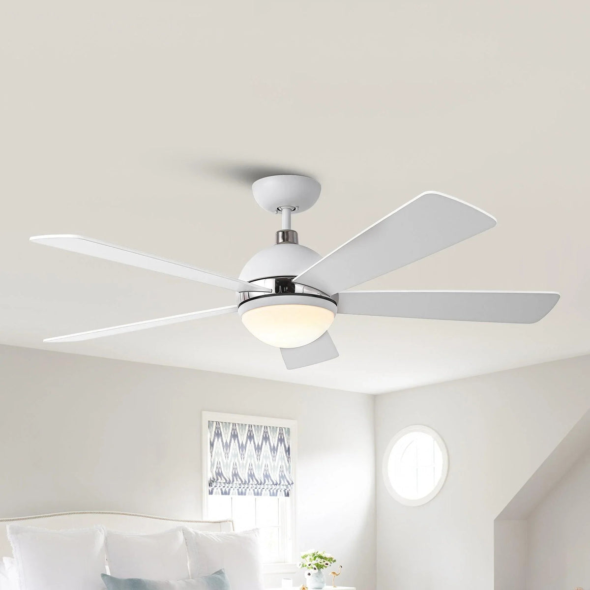 Ceiling fan with five white blades and frosted LED globe under a chrome mount