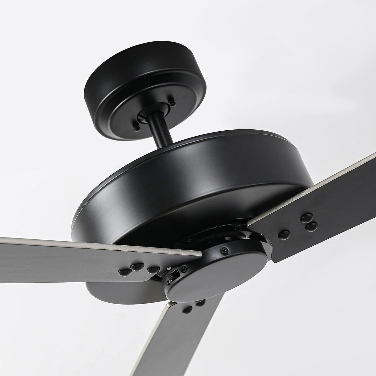 Black ceiling fan motor housing with angled five blades