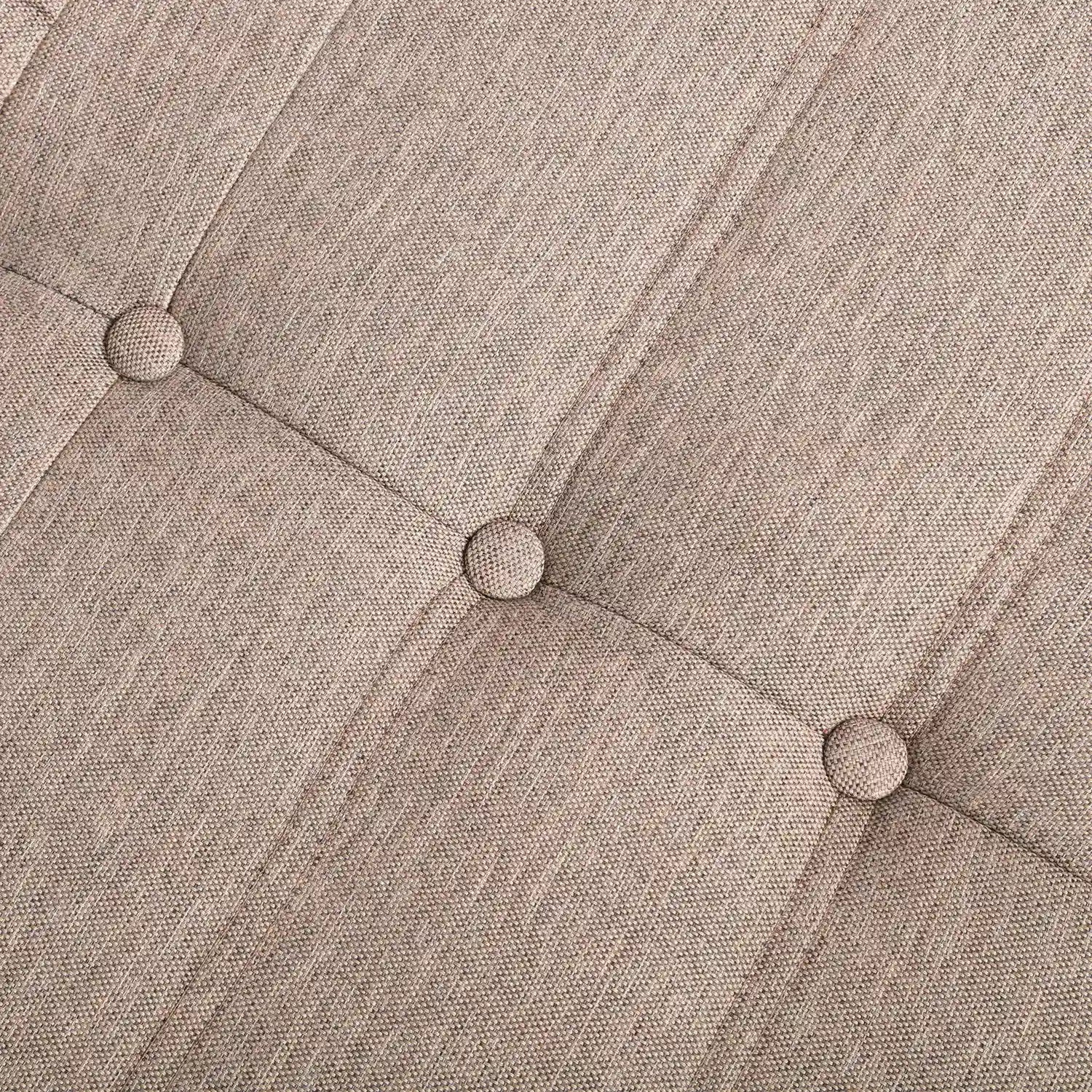 Brown button-tufted upholstery detail with round tuft buttons on a compressed foam couch.