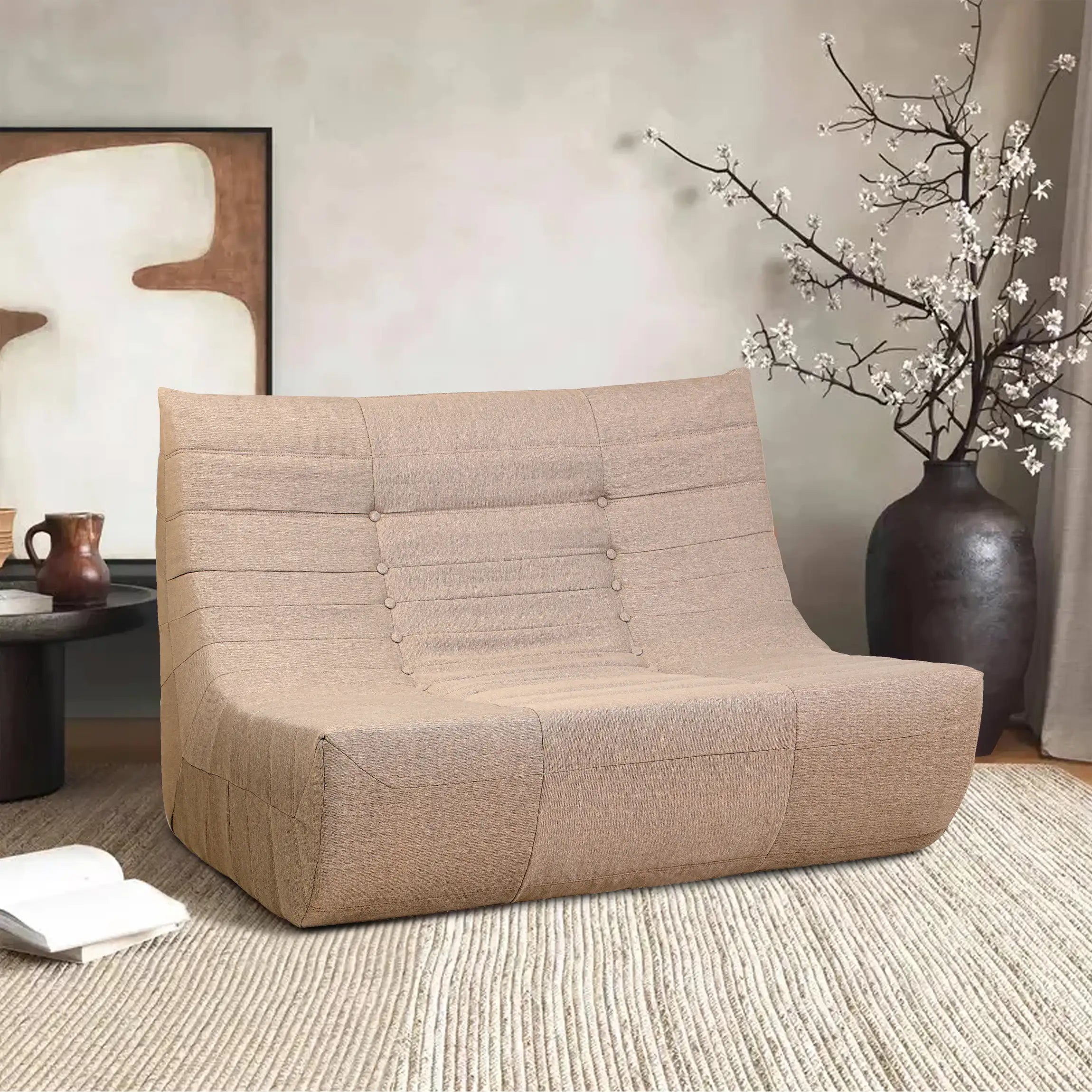 Brown compressed foam sofa in living room setting with tufted back and padded arms