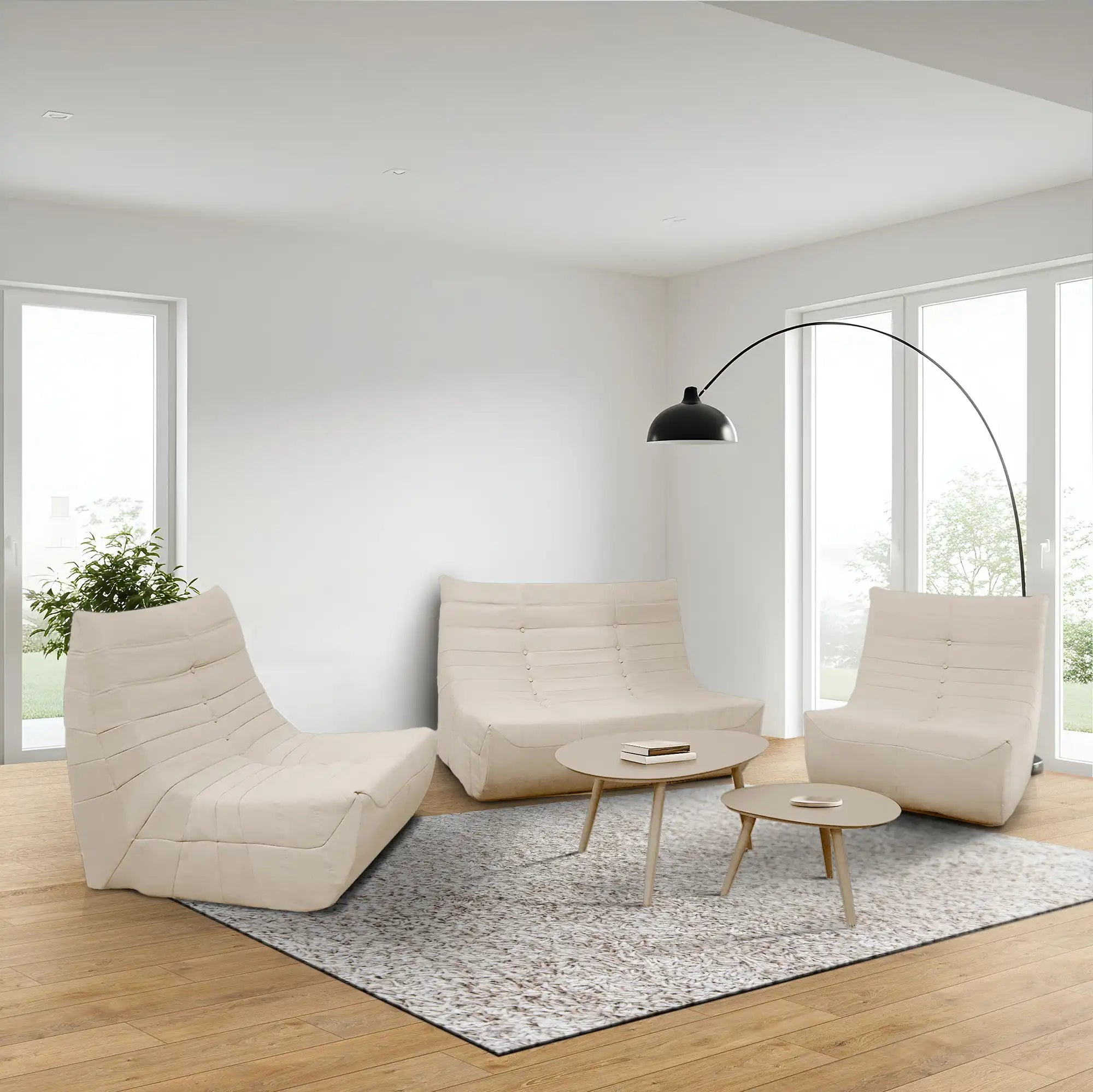 Beige compressed foam lounge set with loveseat, two chairs, and round tables in living room
